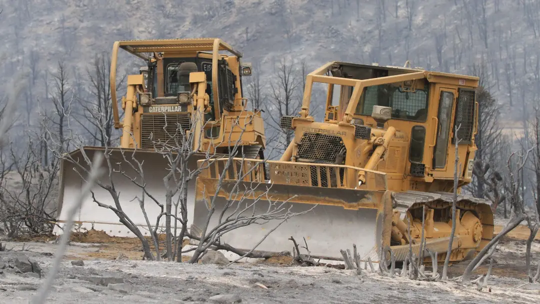 S&K dozers cutting a fire line through a burn area