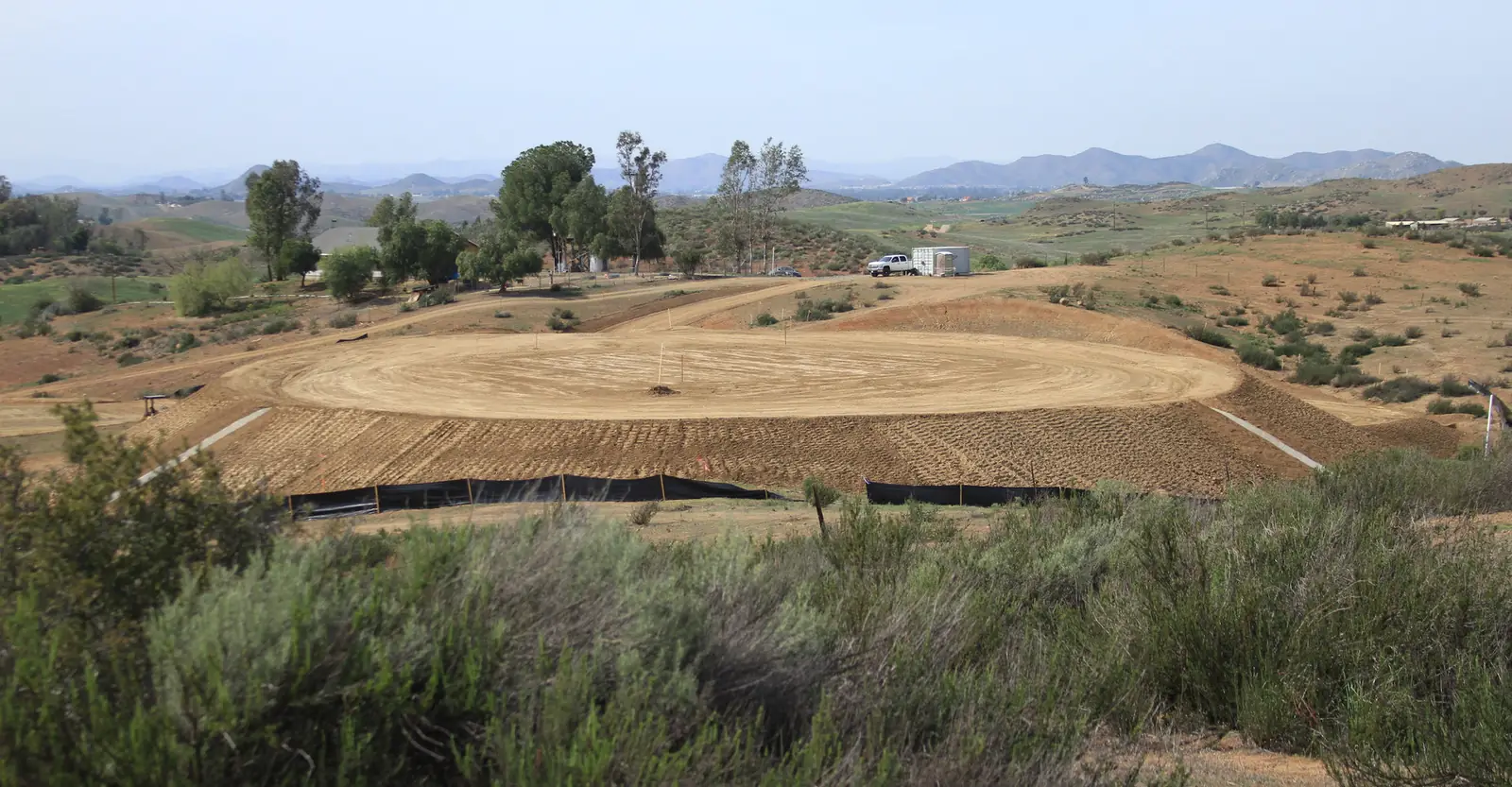 Freshly graded pad in rolling terrain